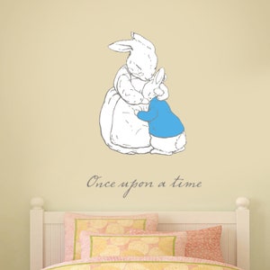 May include: A white rabbit wearing a blue jacket hugs a larger white rabbit wearing a dress. The text "Once upon a time" is written below the rabbits.