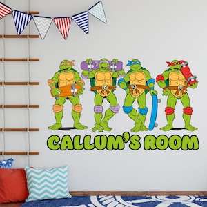May include: Four Teenage Mutant Ninja Turtles characters with green skin, wearing bandanas and holding skateboards. The characters are standing in a row on a white wall with the text "CALLUM'S ROOM" below them.