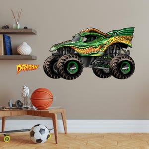 May include: A green and yellow monster truck with a dragon design. The truck has large black tires with green rims and the word "DRAGON" in orange and yellow lettering.
