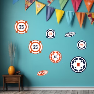 May include: A blue wall with orange and blue circular targets with numbers 10, 25, 50, 75, and the word "NERF" printed on them.