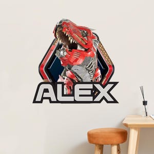 May include: A wall decal featuring a red and silver robotic dinosaur with an open mouth, set within a black and red geometric frame. The name "ALEX" is displayed in bold, white letters below the dinosaur.