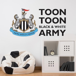 May include: Black and white wall decal featuring the Newcastle United Football Club crest and the text "Toon Toon Black & White Army".