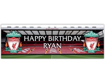 May include: A banner featuring a stadium scene with the text "HAPPY BIRTHDAY RYAN." The Liverpool Football Club logo is on each side. The banner has a green field, red seating, and a white sky.