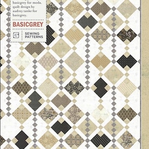May include: A quilt pattern featuring a diamond design in shades of beige, brown, and black. The pattern includes the text "BIJOU BREEZE" and "PAT085" along with "BASICGREY" and "SEWING PATTERNS".