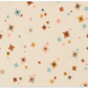 May include: Cream-colored fabric with a repeating pattern of stylized starbursts in shades of brown, gold, teal, and pink. The design is scattered across the fabric, creating a whimsical and retro feel. The fabric has a textured appearance.