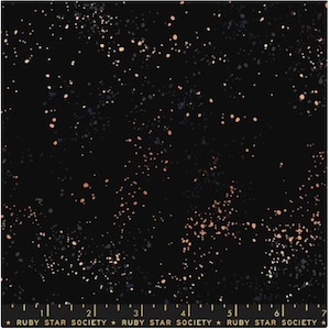 May include: Black fabric with a speckled pattern in shades of peach, gray, and white. The fabric has a ruler along the bottom edge with the text "RUBY STAR SOCIETY".