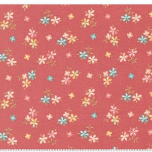 May include: A fabric with a repeating floral pattern. The flowers are in clusters of pink, yellow, and blue on a coral background. Small, single flowers are scattered throughout the design. The fabric has a textured appearance.