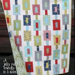 May include: A colorful quilt with a repeating pattern of rectangular blocks in red, blue, green, and gray on a white background. The quilt is labeled "Off track" and "Cluck Cluck Sew". The quilt is a jelly roll friendly quilt in 3 sizes.