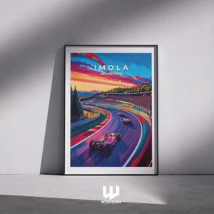 May include: Framed art print of the Imola Grand Prix. The image shows race cars on a track with a colourful sunset. The text "IMOLA GRAND PRIX" is at the top. The artwork is set in a black frame.