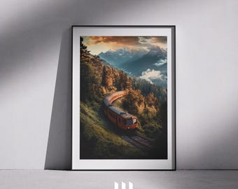 May include: Framed print featuring an orange train winding through a lush, green mountain landscape. The train travels along a curved track, surrounded by trees and a backdrop of snow-capped mountains under a sunset sky. The artwork is framed in black.