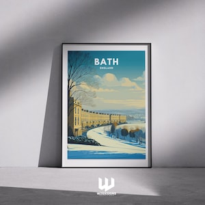 May include: A framed art print of Bath, England, featuring a winter scene. The illustration shows a row of buildings, a road, and the text "BATH ENGLAND". The artwork uses a palette of blues, yellows, and whites to depict a snowy landscape. The print is in a black frame.