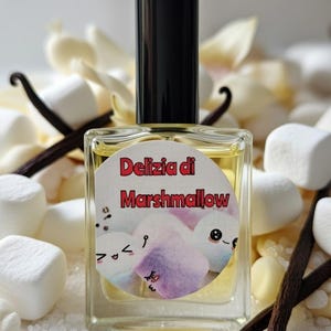 May include: A rectangular glass perfume bottle with a black cap containing a pale yellow liquid. The circular label features the red text Delizia di Marshmallow above a graphic of three smiling, pastel-colored marshmallow characters with faces.