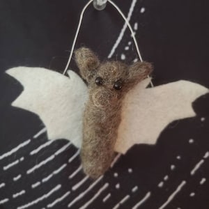 Handmade felted bat with gray body and white wings