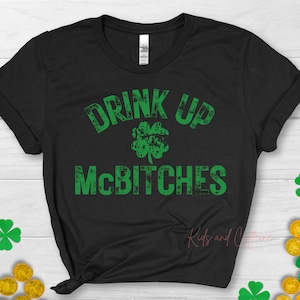 May include: Black t-shirt with a green shamrock and the text "Drink Up McBitches" in a distressed font.