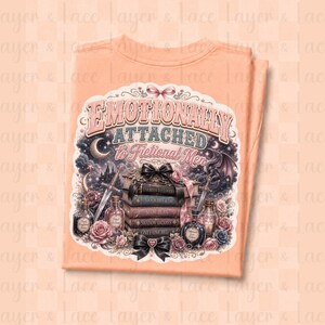 May include: Peach-colored t-shirt featuring a graphic design with the text "Emotionally Attached to Fictional Men." The design includes a stack of books, roses, potion bottles, a castle, and a dragon. The design is in shades of pink, blue, and black.
