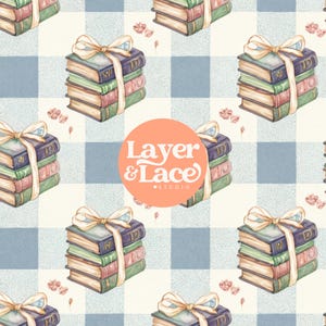 May include: A repeating pattern featuring stacks of three books tied with a cream-colored ribbon bow, set against a light blue and white checkered background with small pink floral accents and a central orange circle with Layer & Lace Studio text.