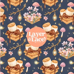 May include: A dark blue fabric pattern featuring illustrations of s'mores with melted chocolate and marshmallows, pink mushrooms, small lanterns hanging from branches, and light pink flowers. A circular orange logo reads Layer & Lace Studio.