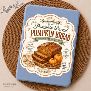 May include: A rectangular light blue fabric item featuring a printed label for Maple Hollow Mercantile Pumpkin Bread. The graphic displays a loaf of pumpkin bread, two small pumpkins, cinnamon sticks, and text including Net Wt. 24 oz.