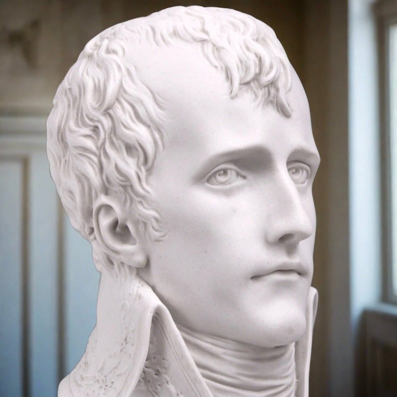 May include: A white marble bust sculpture of a man with short hair. The sculpture is detailed and realistic, capturing the man's facial features.