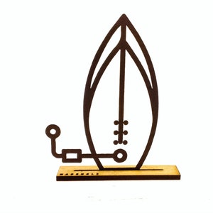 May include: A black wooden surfboard silhouette with a small wooden base. The base has the word "HABENHOLZ" printed on it.