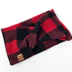 May include: Red and black buffalo plaid fleece headband with a brown leather tag that says "Rustic Flair".