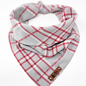 May include: Gray and red plaid dog bandana with a brown leather patch that says "Pawsitive Vibes".