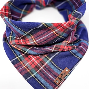 May include: A blue and red plaid bandana with a brown leather patch that says "Pawsitive Vibes".
