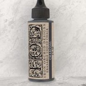 May include: A bottle of Iron Orchid Designs erasable liquid chalk in the color Charcoal. The bottle is black with a black cap and a label with the company logo and product name.