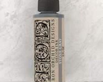 May include: A bottle of Iron Orchid Designs Decor Ink in the color Stone Gray. The bottle is 2 oz and has a black cap.