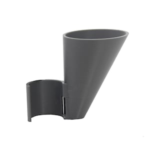 May include: A gray plastic funnel with a curved holder attached to the side. The funnel is designed to hold a small amount of liquid.
