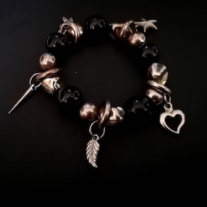 Black and Silver Coloured Beaded Bracelet - feather heart stake spike charm