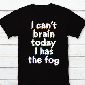 May include: Black t-shirt with a rainbow-colored graphic that says "I can't brain today I has the fog"