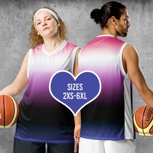 May include: Two basketball jerseys with a gradient design in pink, white, and black. The jerseys have a sleeveless design and a white trim around the neck. The text "SIZES 2XS-6XL" is displayed in a blue heart shape.