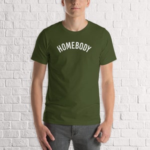 May include: A green t-shirt with the word "HOMEBODY" printed in white on the front.