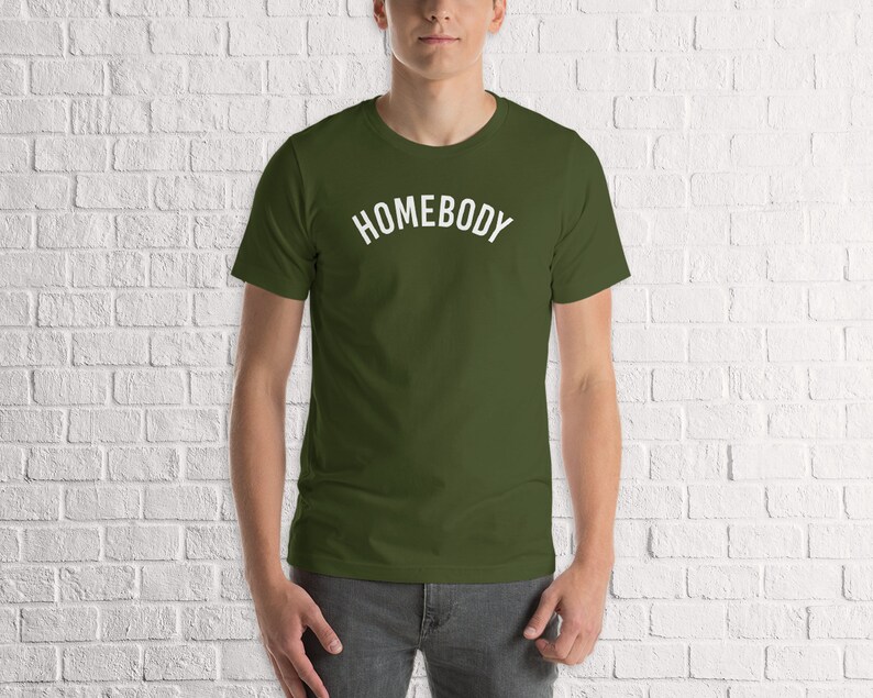 May include: A green t-shirt with the word "HOMEBODY" printed in white on the front.