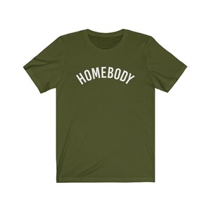 May include: A green short-sleeved t-shirt with the word "HOMEBODY" printed in white on the front.