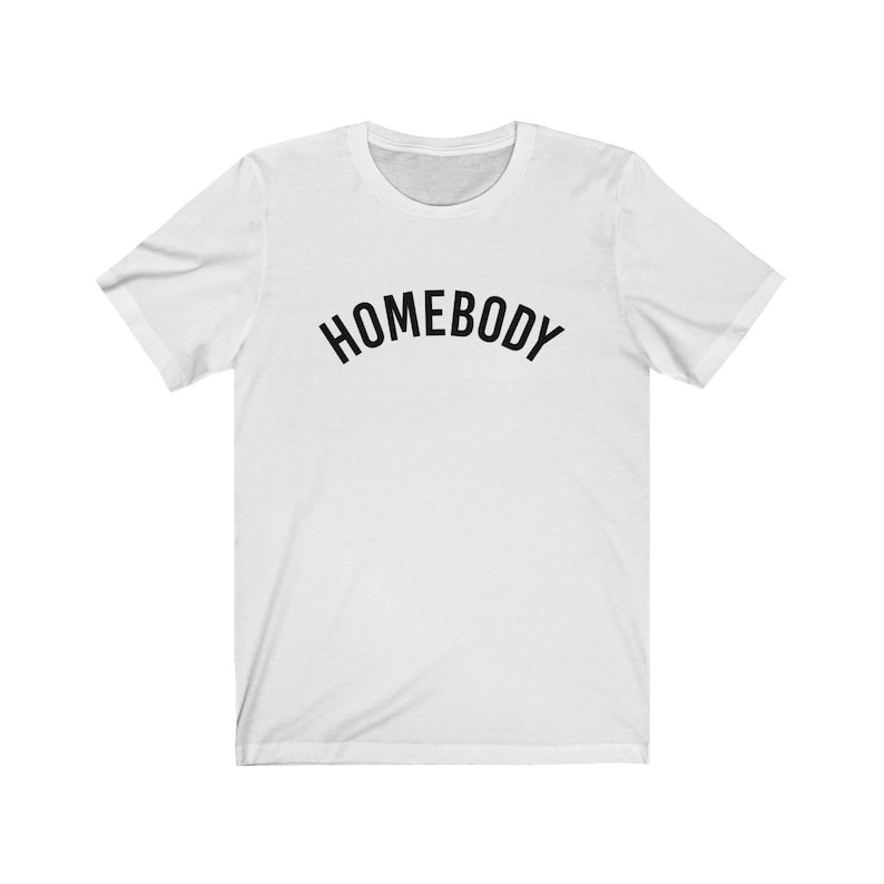 May include: White t-shirt with black text that reads "HOMEBODY" in an arc.