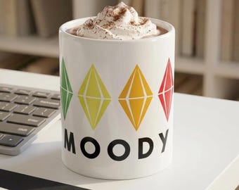 Caneca de cerâmica branca com plumbob verde, amarelo, laranja e vermelho, 325 ml (11 oz) do The Sims com o personagem Moody