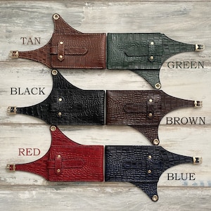 May include: Five leather belts with different colored crocodile embossed patterns. The belts are labeled "TAN", "GREEN", "BLACK", "BROWN", and "BLUE".