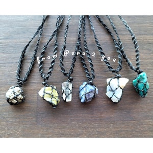 May include: Seven necklaces with different colored stones encased in a black macrame net. The necklaces are all on a black cord and have the text "from Peru 2 you" in the center of the image.