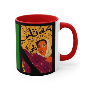 May include: A red and white ceramic mug with a black and green design. The design features a woman with a colorful headscarf and the Arabic text "جميل" which means "beautiful".