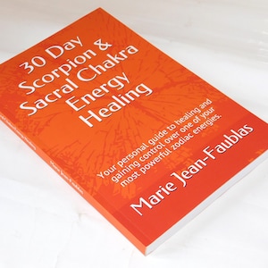 May include: A book titled "30 Day Scorpion & Sacral Chakra Energy Healing" by Marie Jean-Faublas. The cover is orange with white text and a textured design. The book's subtitle reads "Your personal guide to healing and gaining control over one of your most powerful zodiac energies."
