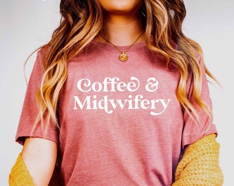 May include: A woman wearing a mauve t-shirt with the text "Coffee & Midwifery" in white. She is wearing blue jeans and a yellow cardigan.