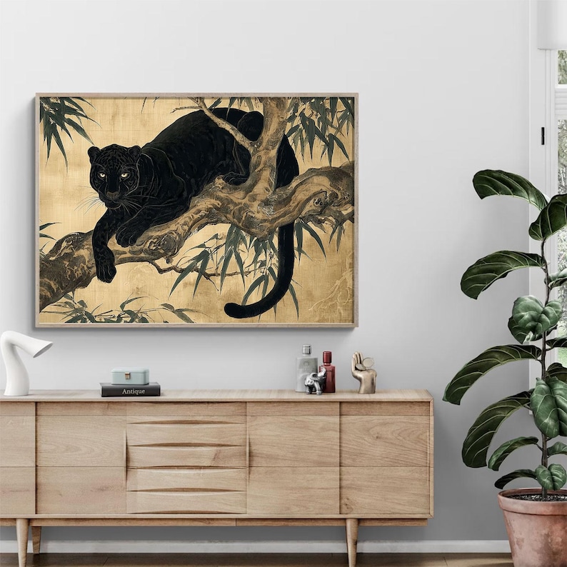 May include: A framed art print featuring a black panther resting on a tree branch. The artwork has a gold background with bamboo leaves. The panther is depicted in a detailed, realistic style, with its fur and features clearly visible.