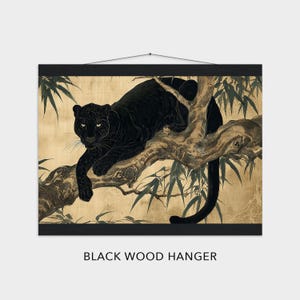 May include: A black wood hanger displaying a print of a black panther resting on a tree branch. The panther is depicted in a detailed, artistic style with a golden background and bamboo leaves. The text "BLACK WOOD HANGER" is at the bottom.