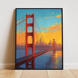 May include: A framed art print depicting the Golden Gate Bridge in San Francisco. The bridge is rendered in red and orange hues, set against a blue sky and a golden sunset. The artwork captures the bridge's iconic structure and the city skyline.