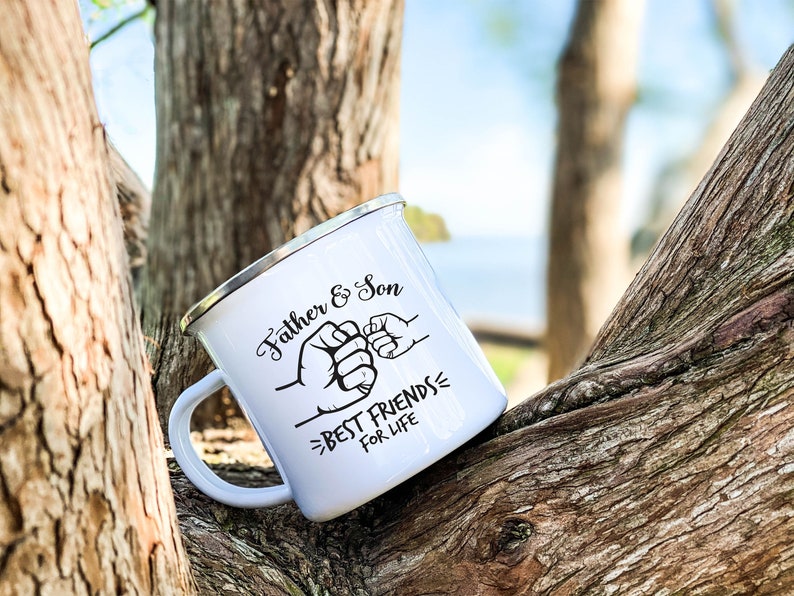 May include: White enamel camping mug with a black design of two fists bumping, with the text "Father & Son - Best Friends For Life".