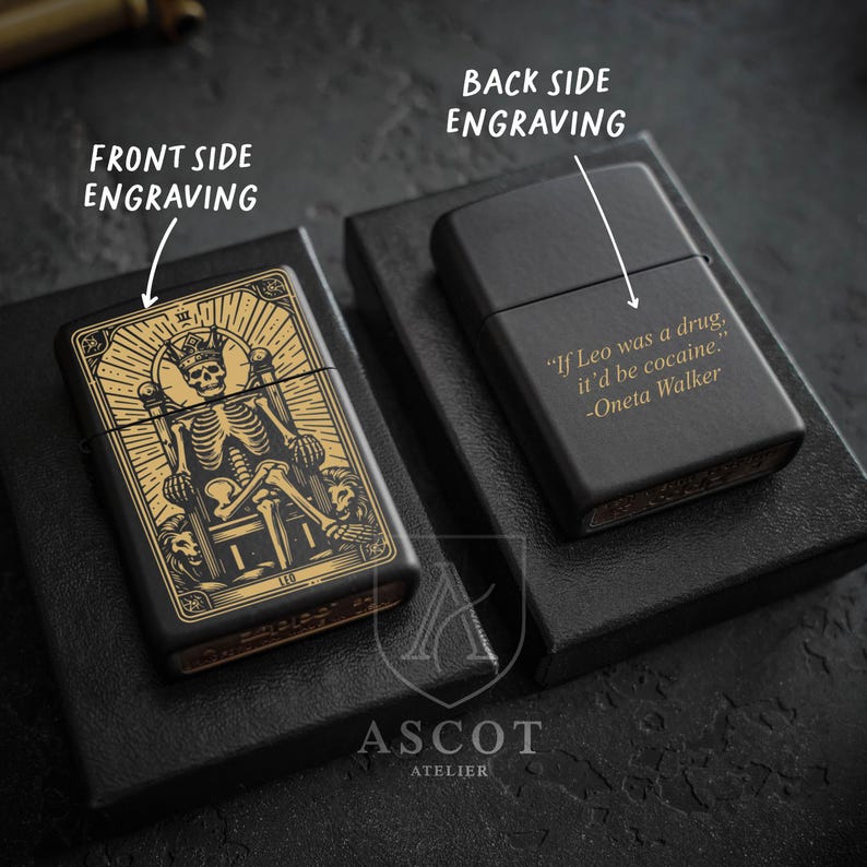 May include: Two matte black metal lighters. The left lighter features a gold-toned engraving of a skeleton wearing a crown on a throne with the text LEO. The right lighter features a gold-toned engraving with the text If Leo was a drug, it'd be cocaine. -Oneta Walker.
