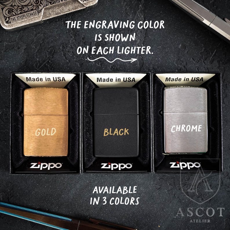May include: Three Zippo lighters in gold, black, and chrome finishes, each displayed in a black box with the text Made in USA. The lighters feature the words GOLD, BLACK, and CHROME engraved on the front. Text reads: THE ENGRAVING COLOR IS SHOWN ON EACH LIGHTER. AVAILABLE IN 3 COLORS.