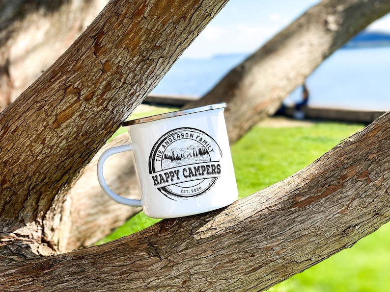 May include: White enamel camping mug with a black and white logo that says "The Anderson Family Happy Campers Est. 2020".